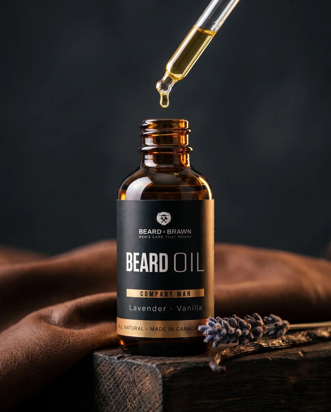 Amber beard oil bottle with a drop falling from the dropper